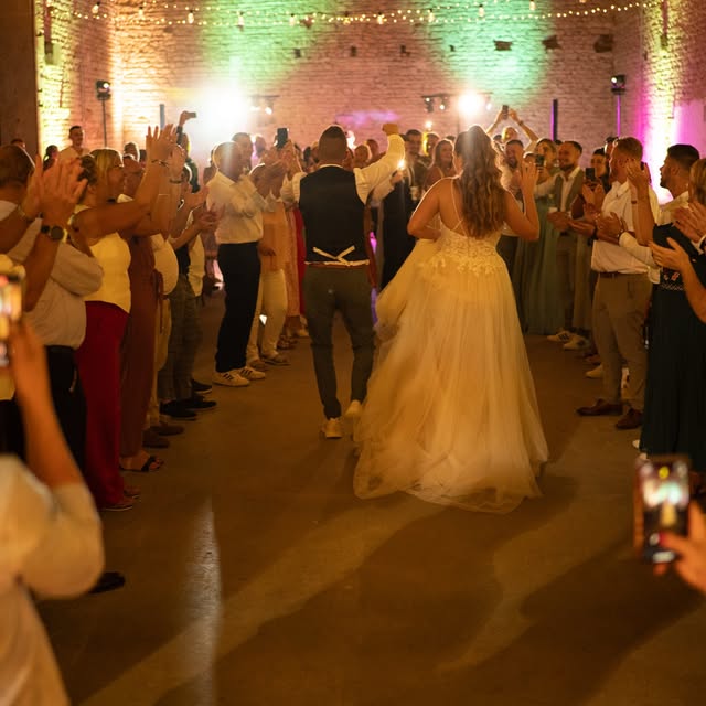 A crowded wedding dance floor, with guests celebrating together